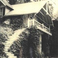 Stone cottage at Kenmure with plant-covered stairs and porch