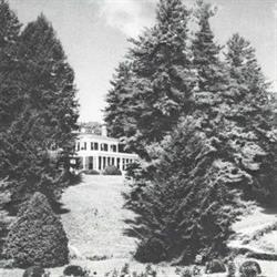Old black and white photo, clubhouse with ancient Greek architecture, surrounded by trees